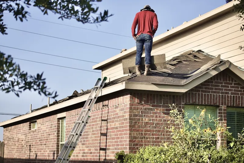 Professional roofer working on a residential roof in Saint Ives Country Club